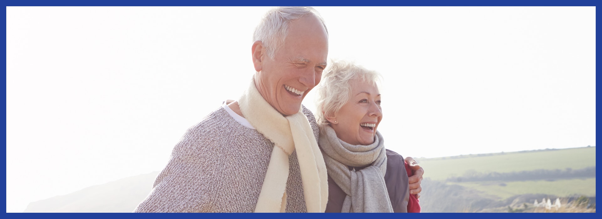 a senior couple walking outside and smiling