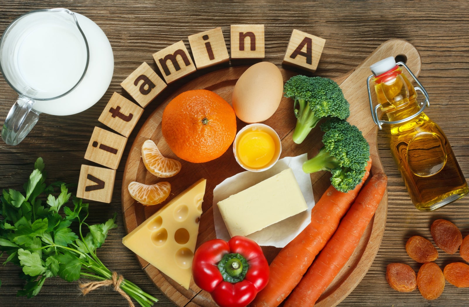 A variety of foods that are a good source of Vitamin A, Like milk, cheese, carrots, bell pepper, carrots, broccoli, parsley, and oranges.