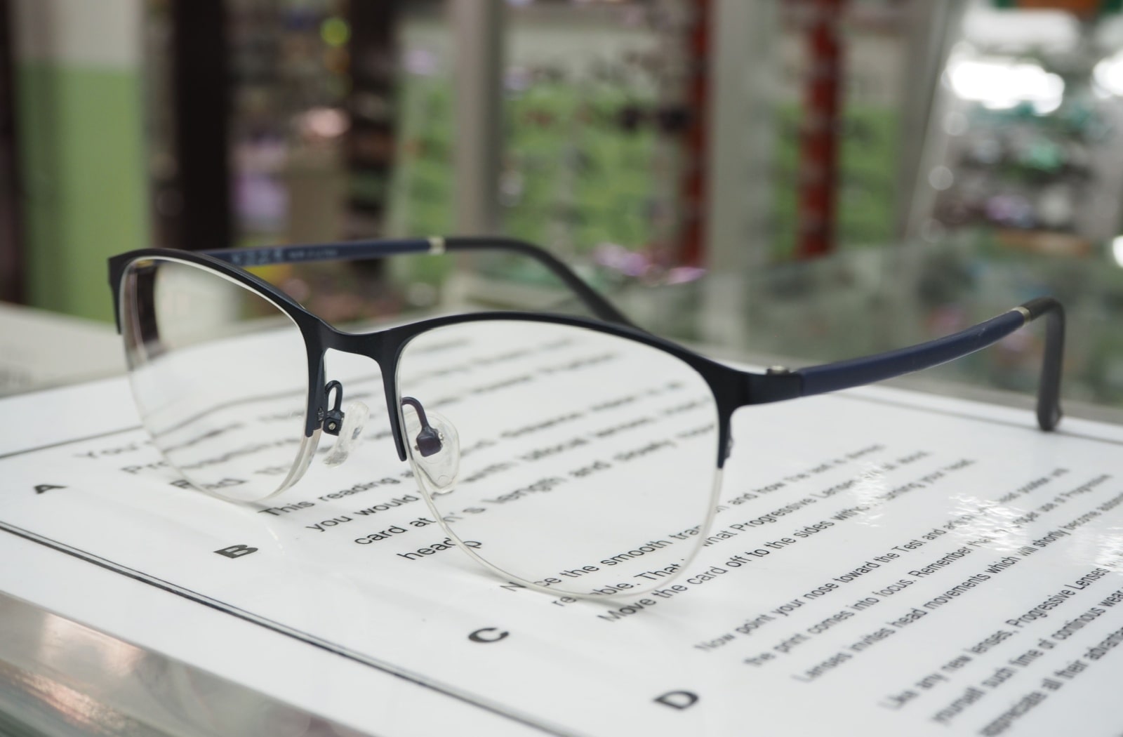 A pair of reading glasses sitting on top of a book