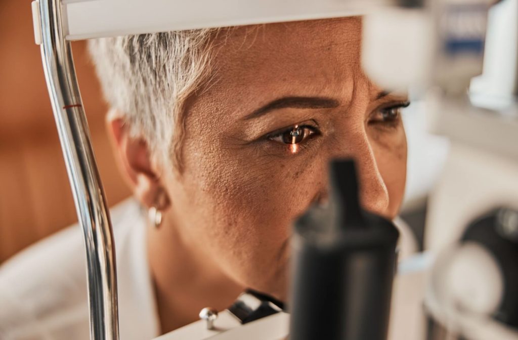 A close-up image of a senior woman during an eye exam.