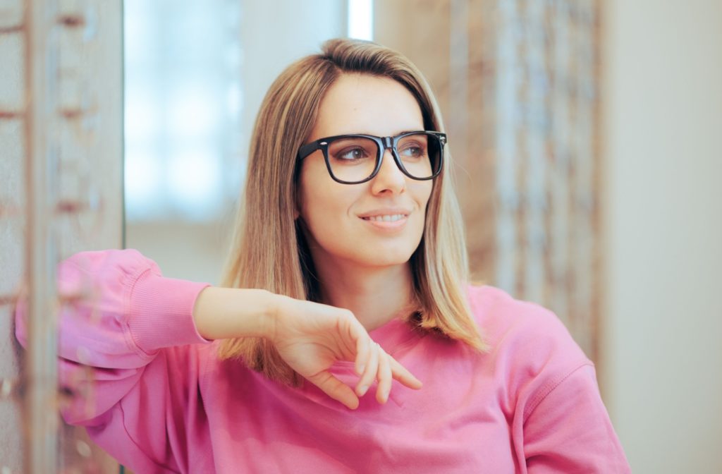 A person wearing a pair of retro glasses looking fashionable and on-trend.